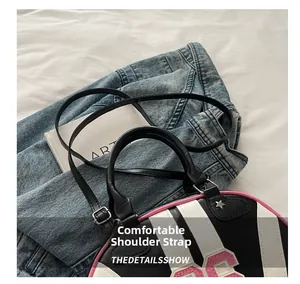 Detail showing the comfortable adjustable shoulder strap on the striped semi-round bag
