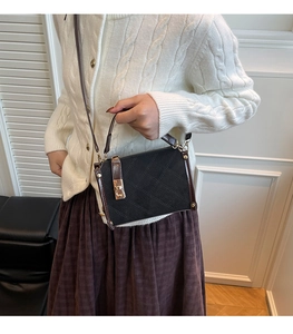 Detail of suede crossbody bag with rhombus quilting and contrast leather trim
