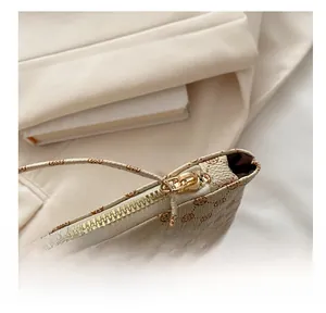 Detailed macro view of high-quality golden metal zipper on vintage floral envelope bag