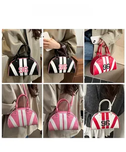 Detailed views of semi-circular striped bag with number 96 patch and star rivets