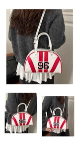 Detail of Boston bag showing digital 96 patch embroidery and red stripes on white PU leather