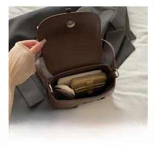 Internal view of brown leather saddle bag showing large storage capacity for daily items