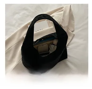 Spacious black suede hobo bag interior showing smartphone and umbrella storage