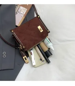 Detail of quilted brown suede shoulder bag showing large capacity for essentials