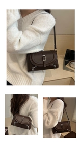 Detail view of dark coffee faux leather shoulder bag with silver buckles and zippers