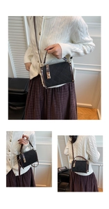 Detail of black quilted crossbody bag showing gold lock and brown leather strap on a model