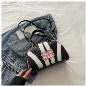 Detail of Boston shoulder bag with black and white stripes and pink number 96 patch