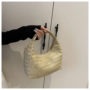 Close-up of beige woven hobo bag showing detailed herringbone pattern and top zipper