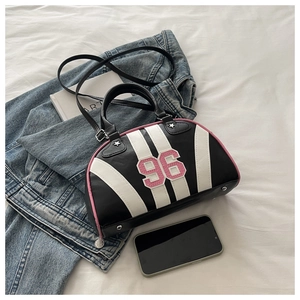 Detail of Boston bag showing stripes, number 96 patch, and star-shaped handle hardware