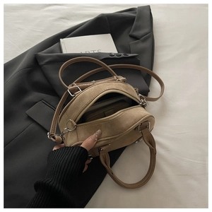 Capacity view of khaki suede bowling bag showing interior wallet storage and texture