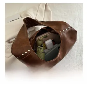 Internal view of brown vintage shoulder bag showing large capacity for daily items