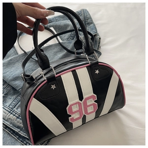 Detail view of the black retro bowling bag with pink number 96 patch and silver stars