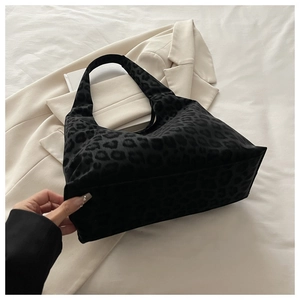Detail of leopard print tote bag with soft flocked texture on a neutral background