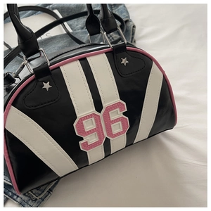 Detail of Y2K vintage black Boston bag with pink number 96 patch and star rivets