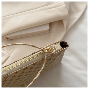 Macro detail of envelope crossbody bag with geometric floral print and gold-tone zipper