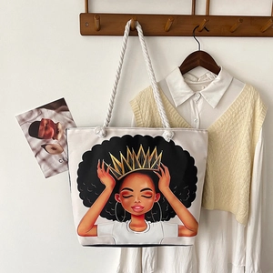 Detail of canvas tote bag featuring thick cotton rope handles and a cartoon girl print