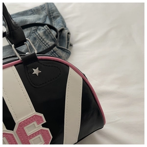 Detail of retro bowling bag showing number 96 patch and star rivet on leather