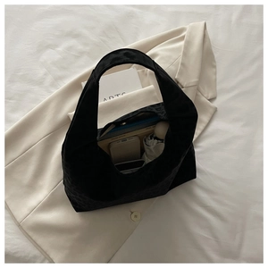 Internal view of black tote bag showing spacious capacity for phone, umbrella, and notebook