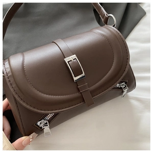 Detail view of coffee brown PU leather shoulder bag with silver zippers and buckle strap