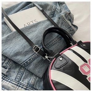 Detail of retro striped shoulder bag with star rivets on denim jacket background