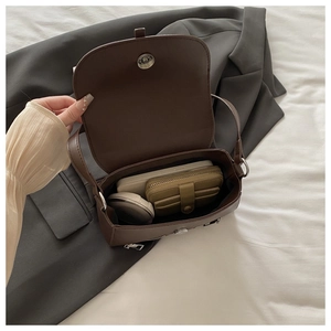 Internal view of a dark brown leather shoulder bag showing phone and wallet storage