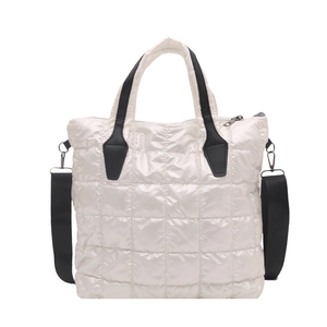 White quilted tote bag with black handles and shoulder strap in high-gloss nylon