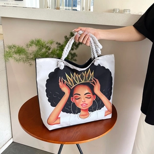 Detail of white canvas tote with cartoon girl illustration and thick cotton rope handles
