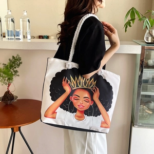 Close-up of a large canvas tote bag featuring an artistic illustration and rope handles