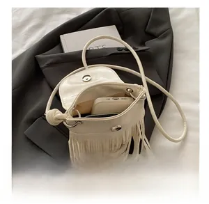Detail view of the fringe crossbody bag interior showing phone and wallet storage space