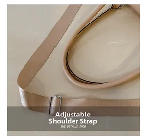 Detail of adjustable woven shoulder strap with silver buckle and beige leather handle