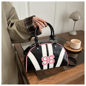 Detail of retro black shoulder bag with pink 96 embroidery and stripe accents