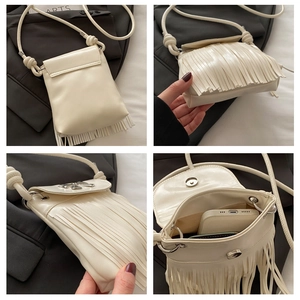 Detail view of cream fringe bucket bag with bow ornament and magnetic closure
