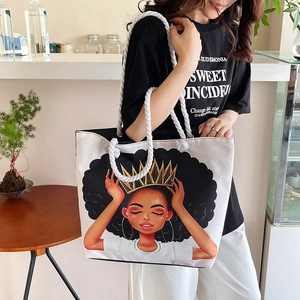 Detailed shot of large canvas tote bag with artistic graphic print and rope handles
