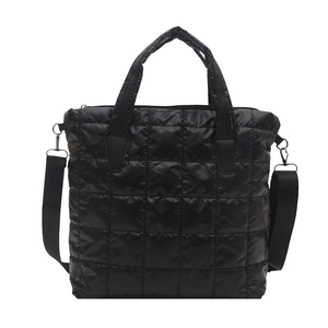 Fashionable black quilted puffer tote bag with adjustable strap and square texture