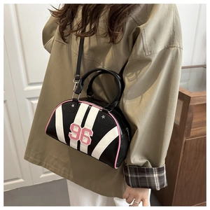 Detail of retro sporty crossbody bag with pink 96 embroidery and star metal rivets