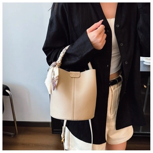Beige lychee texture leather bucket bag with printed silk scarf handle and shoulder strap