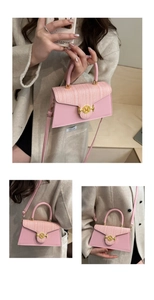 Detail of pink faux leather and tweed crossbody bag with golden metal logo buckle