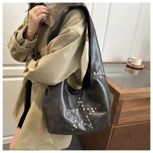 Deep brown matte leather Hobo bag featuring silver rivet star design on model