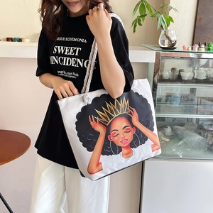 Detail of white canvas tote bag with artistic crown girl print and thick cotton rope handle