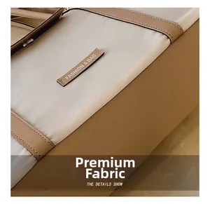 Close-up of textured fabric and brown leather stitching with a fashion brand tag