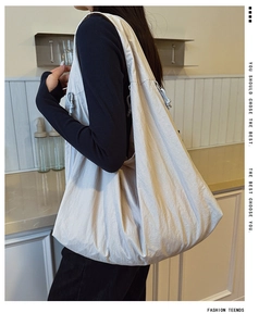 Detail view of large cream hobo bag with side drawstring and cloud-like pleat texture