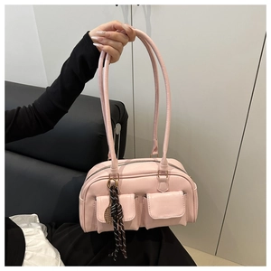 Detailed close-up of pink PU leather underarm bag featuring two front flap pockets