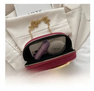 Internal view of dark red velvet evening bag showing space for phone and makeup