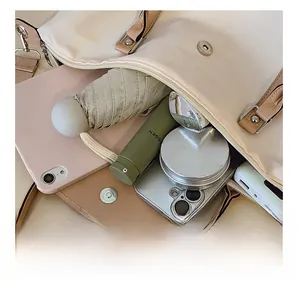 Interior view of the cream dumpling bag showing spacious capacity for daily essentials