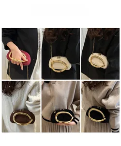 Multiple views of mini velvet evening bags with large oval gold handles and chain straps