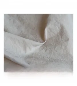 Close-up of cream cotton linen fabric showing natural texture and soft wrinkles