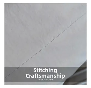 Macro detail showing precise stitching and grey fabric texture on the stylish tote bag
