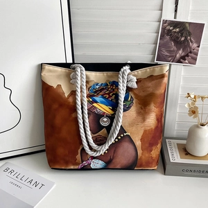 Detail of artistic woman illustration on a beige canvas tote bag with cotton rope handles