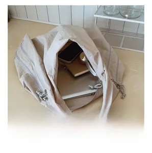 Spacious interior of beige canvas tote bag showing laptop and daily essentials