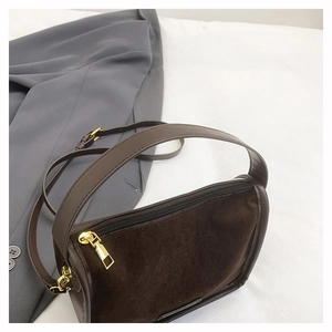 Detail of coffee brown crossbody bag showing suede and smooth leather stitching textures